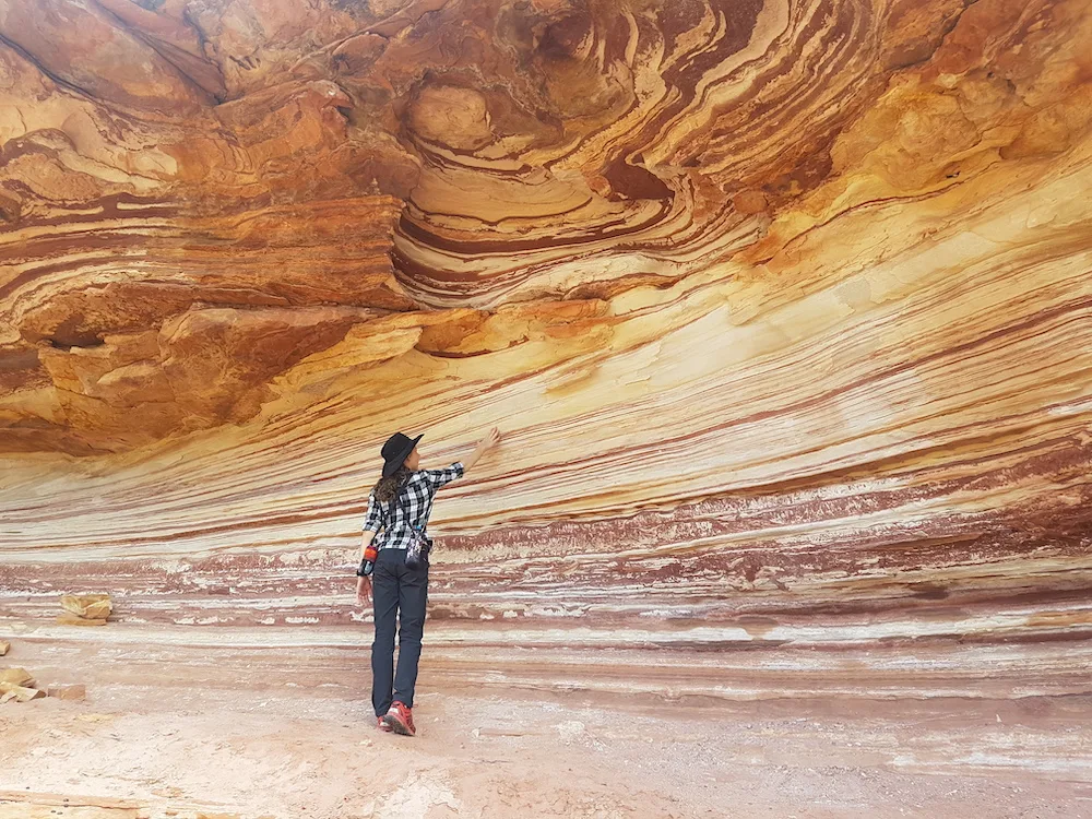 Girl observing colourful rock wall at Kalbarri