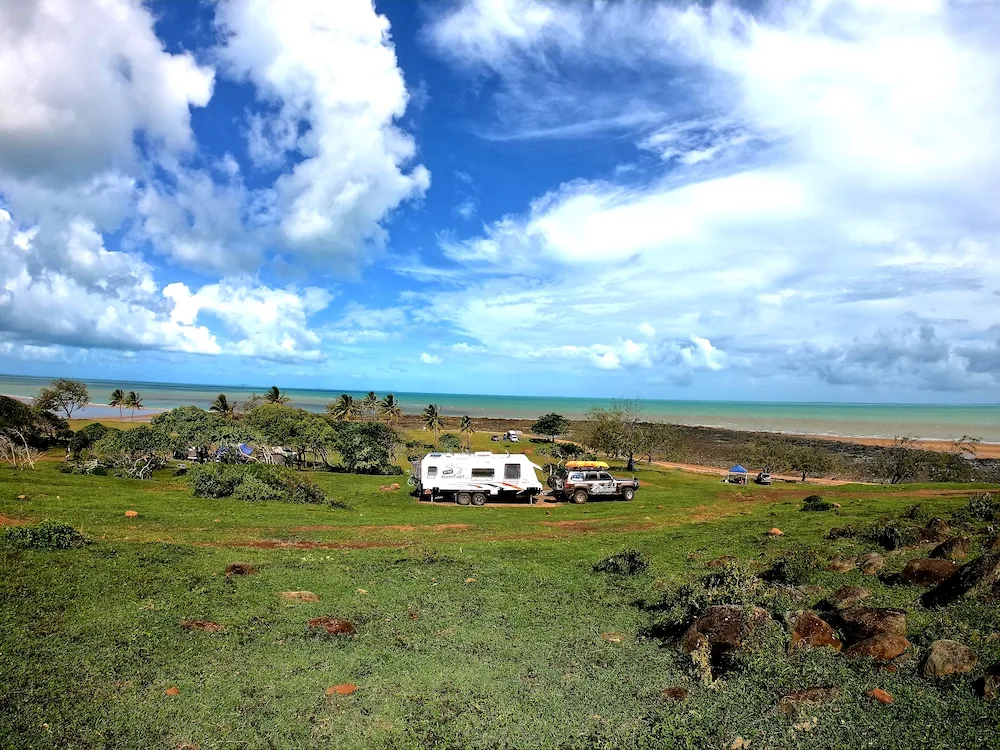 Caravan parked in green pasture