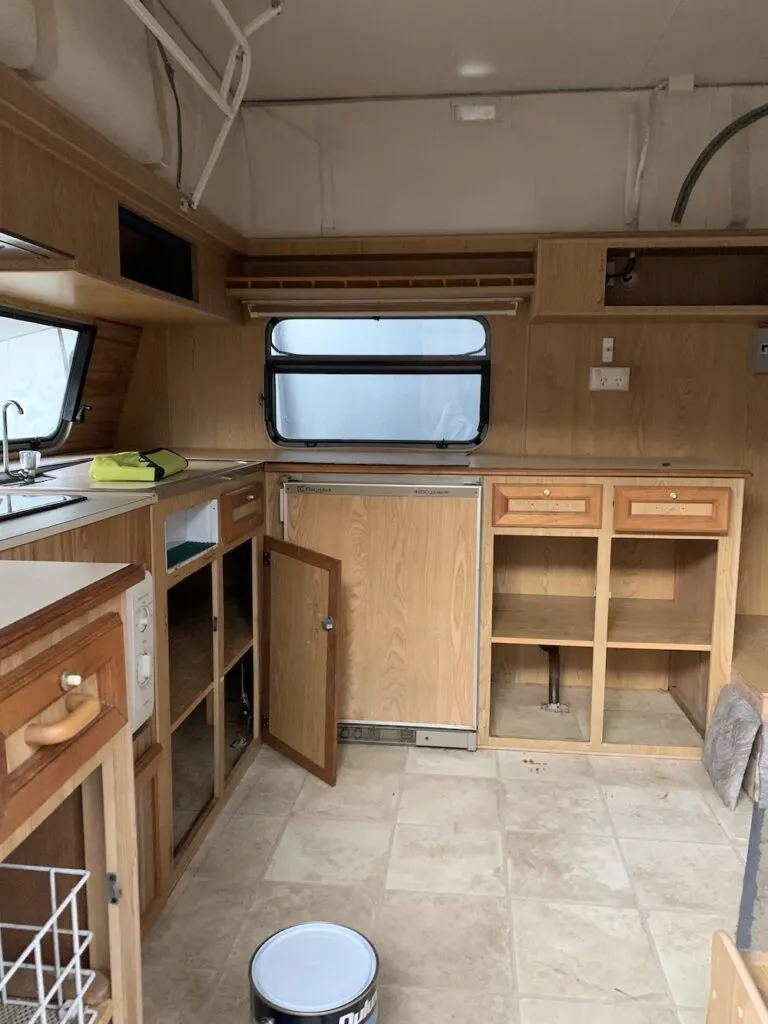 Brown kitchen cabinets inside a vintage caravan
