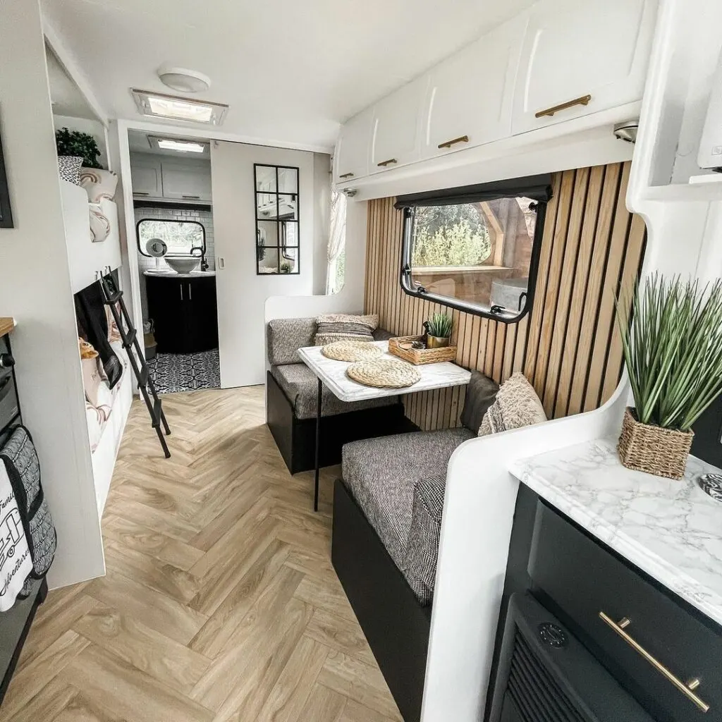 Light interior of a renovated caravan showing neutral decor.