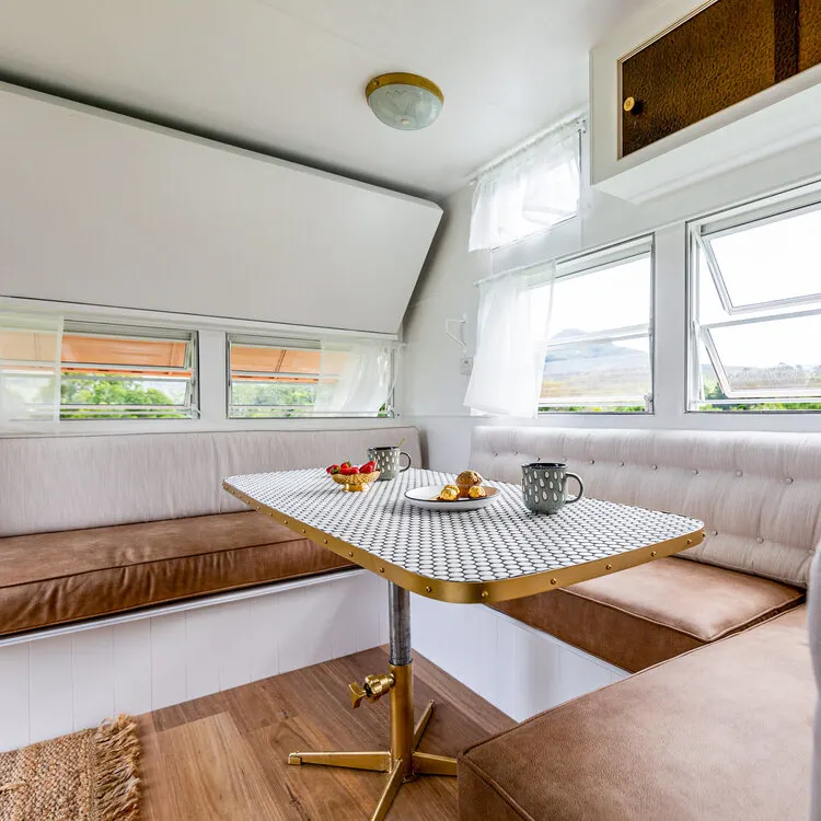 Dining area inside a renovated retro caravan.